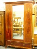 AN EDWARDIAN INLAID MAHOGANY MIRRORED WARDROBE with classical urn and floral swag detail, 208cms