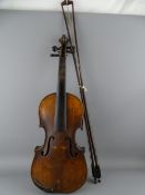 A VINTAGE WELL USED VIOLIN AND TWO BOWS interior spurious 'Stradivarius' label dated 1720, 59cms