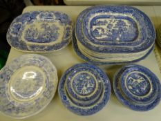 A QUANTITY OF BLUE AND WHITE DINNERWARE including ten 'Willow' pattern meat platters