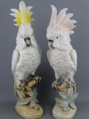 TWO ROYAL DUX PORCELAIN MODELS OF PARAKEETS, one tinted pink the other yellow, 41cms heights
