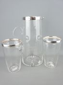 A VICTORIAN GLASS LEMONADE JUG AND TWO BEAKERS WITH SILVER COLLARS, Sheffield 1865, Atkin Brothers