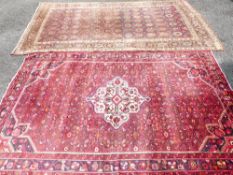 AN IRANIAN RED GROUND CARPET AND ONE OTHER, classical colourful design with a triple bordered