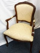 A FRENCH REGENCY STYLE MAHOGANY ELBOW CHAIR with cream floral seat and back and padded arms