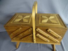 AN INLAID TEAK CANTILEVER SEWING BOX AND CONTENTS