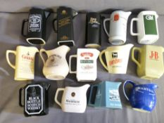 A COLLECTION OF 14 WHISKEY ADVERTISING WATER JUGS