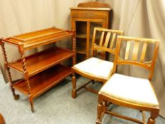 A THREE TIER BARLEY TWIST TEA TROLLEY, an oak single door bookcase, two vintage side chairs and a