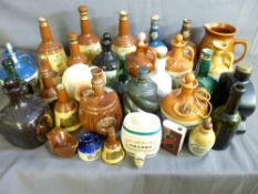A GOOD COLLECTION OF POTTERY AND GLASS WHISKEY FLAGONS, Wade Bells and other drink containers