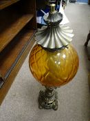 A CONVERTED BRASS OIL LAMP with circular amber glass shade