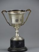 TWIN HANDLED INSCRIBED SILVER TROPHY CUP ON A PLINTH, 5 troy ozs Birmingham 1935