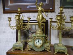 A FRENCH ONYX AND GILT METAL THREE PART CLOCK GARNITURE with Japy movement, central clock with a