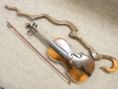 AN OLD VIOLIN AND BOW with mother of pearl detail and a crooked walking stick
