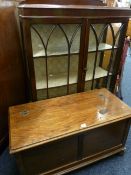A POLISHED BLANKET CHEST and a polished two door glazed front china cabinet with back rail