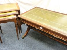 A REPRODUCTION SOFA COFFEE TABLE on claw supports, a nest of three mahogany coffee tables and a