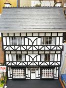 THE LADIES' SHOP - A half timbered Tudor style three storey house under a slate roof, fully