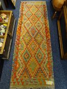 A VEGETABLE DYE WOOL CHOBI KELIM RUNNER colourful repeating central diamond block pattern with