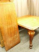 A VICTORIAN MAHOGANY PULL-OUT EXTENDING DINING TABLE with three additional leaves on substantial