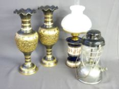 A CHROME AND BLACK JAPANNED TILLEY STORM LAMP with a classically styled Italian table lamp and a