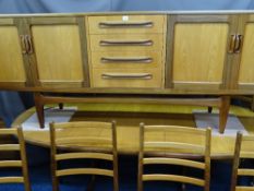 AN EXCELLENT G PLAN LONG SIDEBOARD, extending dining table and six ladder back chairs, 79cms height,