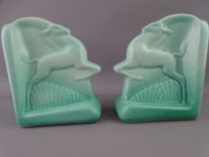 A PAIR OF ROYAL LANCASTRIAN POTTERY BOOKENDS depicting 'Leaping Oryx' in stylised form, impress