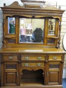A WELL PRESENTED EDWARDIAN CARVED OAK MIRROR BACK SIDEBOARD, the triple mirror top with