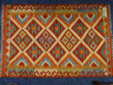 A VEGETABLE DYE WOOL CHOBI KELIM RUG, repeating central diamond block pattern on a colourful
