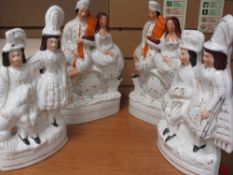 TWO PAIRS OF STAFFORDSHIRE FLAT BACKS - Scottish clock group and another Scottish group