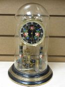A FLORAL DECORATED BRASS & EBONY EFFECT ANNIVERSARY CLOCK in dome