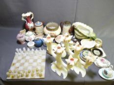 AN ONYX CHESS BOARD AND PIECES, two similar three branch candle holders and a quantity of