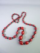 A CHERRY AMBER STYLE AND BAKELITE NECKLACE of graduated beads, 44cms length, 21mm the largest