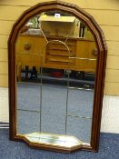 A STYLISH MAHOGANY EFFECT WALL MIRROR with small lower shelf, 104cms height, 67cms width