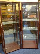 TWO MODERN MEDIUM WOOD EFFECT DISPLAY CABINETS with glass shelves and light fixtures