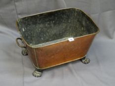 A GEORGIAN COPPER WINE COOLER/PLANTER with iron carry handles and hairy paw feet, 27cms height,