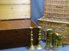 A PAIR OF MATCHING BRASS CANDLESTICKS, other brassware, a wicker basket and a large storage box with