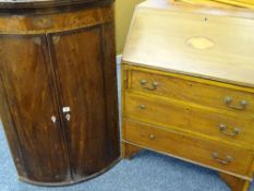 AN EDWARDIAN MAHOGANY BUREAU with shell inlay to the slope front and three drawers to the base (some