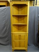 A LIGHTWOOD FLOOR STANDING CORNER CUPBOARD, base cupboard door and upper shelves