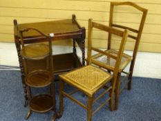 AN OAK TWO TIER TROLLEY, a folding mahogany cake stand and a pair of cane seated chairs, the trolley