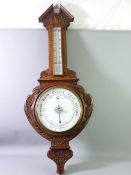 AN OAK FRAMED VINTAGE ANEROID BAROMETER WITH THERMOMETER, 84cms length
