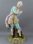 A CONTINENTAL PARIAN FIGURINE of a gentleman standing by a chair with opened book on a circular