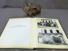 A HEAVY CAST IRON ORNAMENTAL PIG WITH WINGS and an album of historical Liverpool scenes