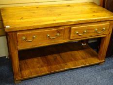 A CHUNKY PINE KITCHEN DRESSER BASE with open pot board and two drawers, 74cms height, 132cms