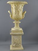 TWIN HANDLED URN AND PLINTH, wide necked urn with classical relief on a square alabaster base, 55cms