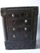 A WELSH SLATE FOLK ART DOORSTOP modelled as a tall chest of dummy drawers with brass knobs (three