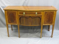 A SHERATON STYLE BOW FRONTED SIDEBOARD with inlaid detail, tambour fronted opening on splayed