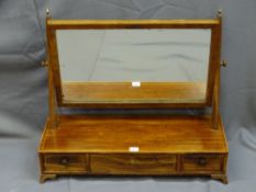 A REGENCY MAHOGANY SWING TOILET MIRROR on a three drawer base with box wood string inlay, 59.5cms