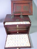 A 19TH CENTURY CHINESE MAHJONG SET in colour tinted bone and bamboo, housed in a five drawer