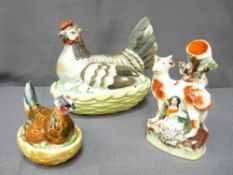 TWO STAFFORDSHIRE HEN ON NESTS and a Staffordshire spillholder of cow and lady