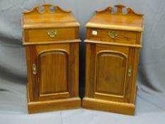 A PAIR OF EASTERN STYLE BEDSIDE TABLES with upper drawer and lower cupboard with rail back