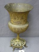 INDIAN CHASE DECORATED GILT BRASS CAMPANA STYLE VASE on a circular pierced leaf six footed stand,