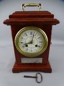 PRESENTATION MANTEL CLOCK with Roman numerals, set enamel dial and bell strike movement, the front