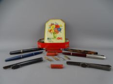 FOUR VINTAGE FOUNTAIN PENS and two steel holders with a small quantity of nibs and sealing wax in